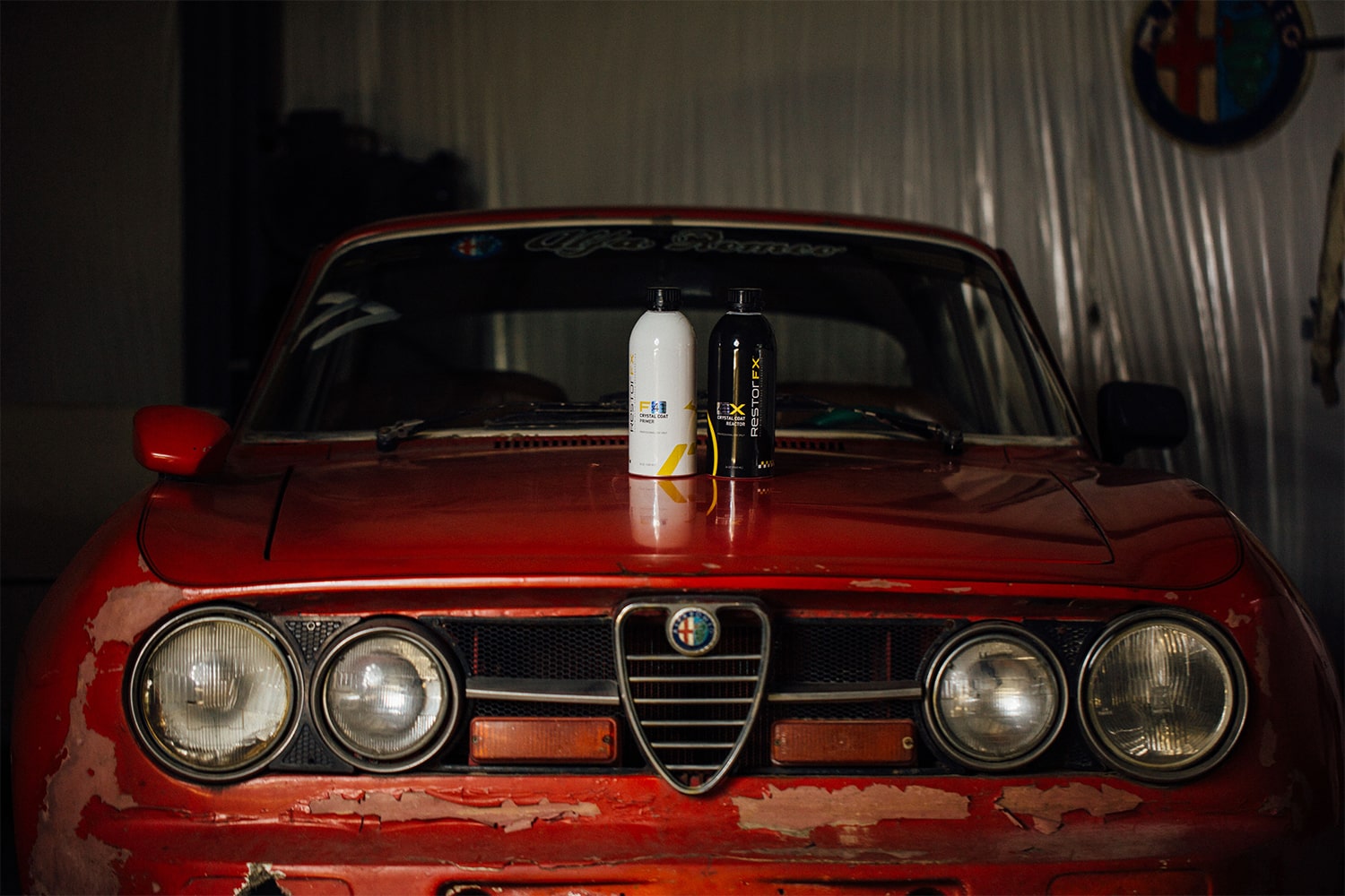 RestorFX F and X product bottles on the hood of a red vintage 1967 Alfa Romeo Giulia Coupe 1750 GTV
