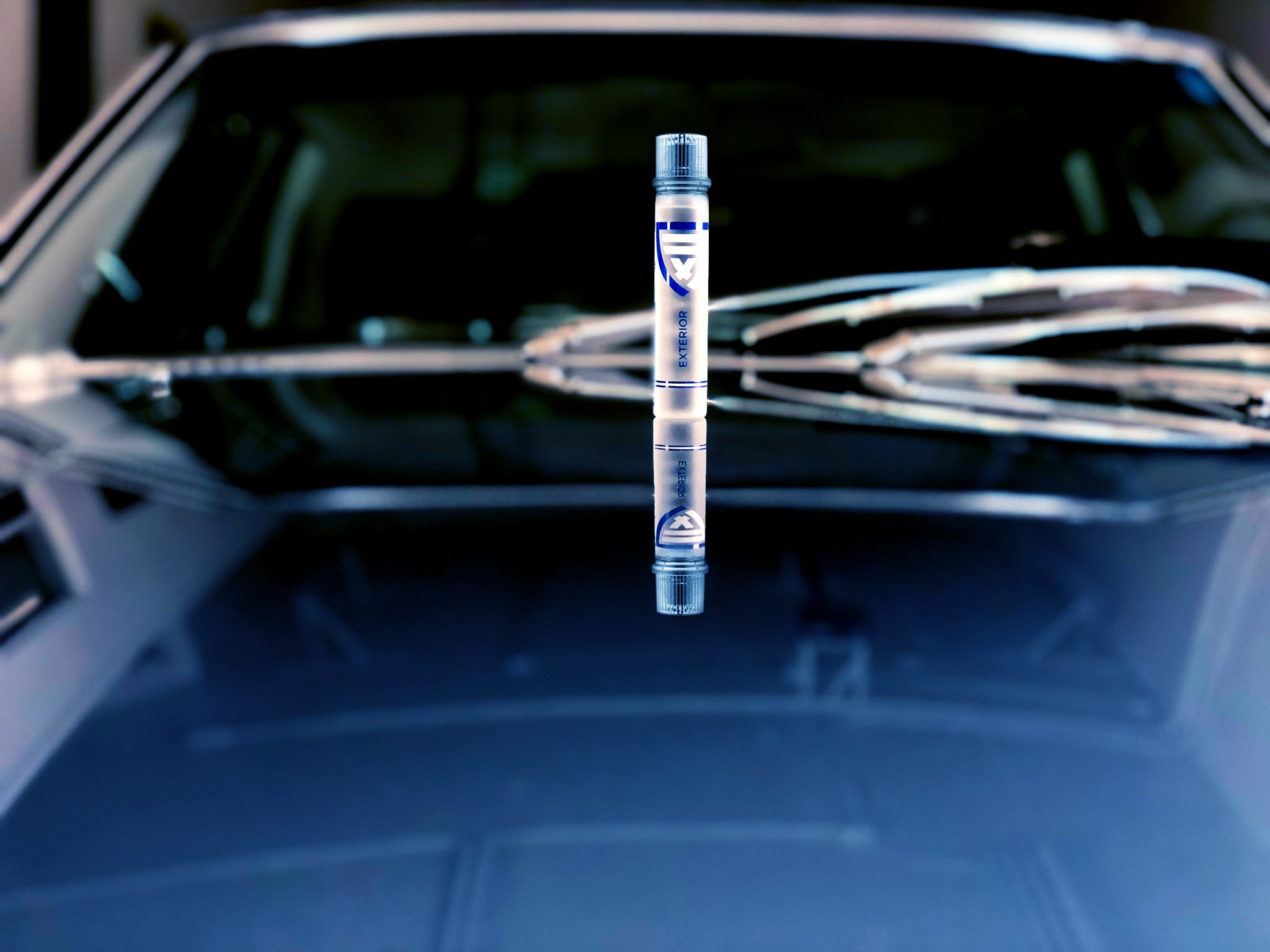 Crystal-clear ClearFX Exterior product bottle on the hood of a blue vintage 1976 Mercedes Benz 500 SL Coupe